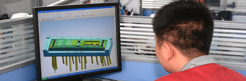 Engineer reviews 3D injection mold CAD model for charging electronics structural design